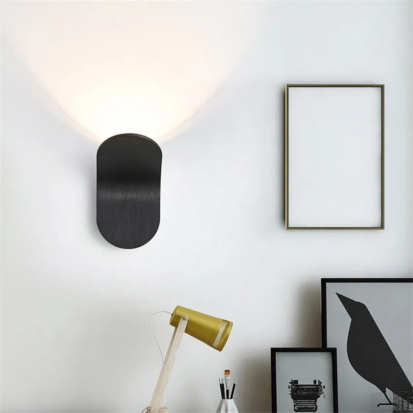 Black Nordic Glow Wall Lamp glowing on a white wall