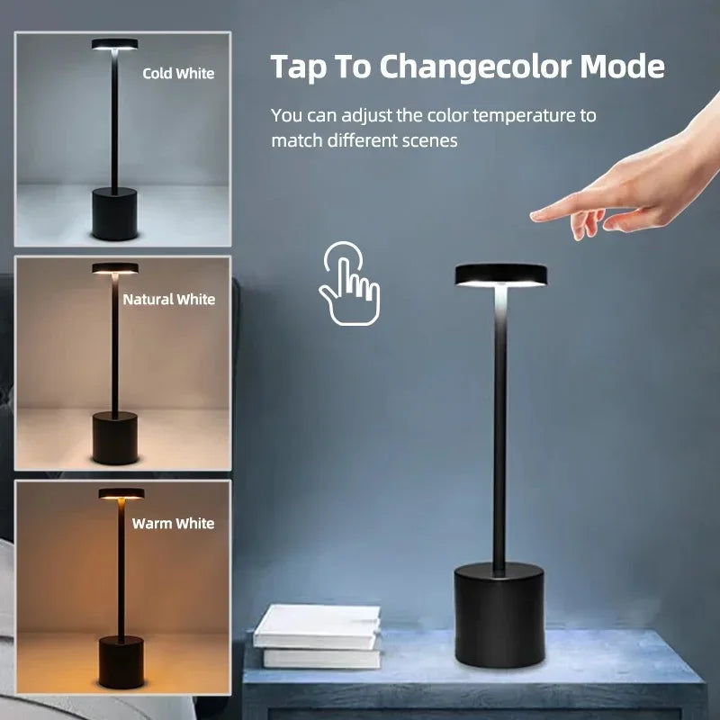 Hand tapping the top of black Touch Glow Cordless Desk Lamps to change the light mode