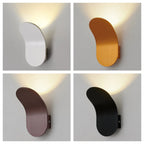Nordic Glow Wall Lamp in four finishes, each casting an upward glow