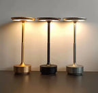 Three Sleek Cordless Table Lamps in gold, black and silver, switched on