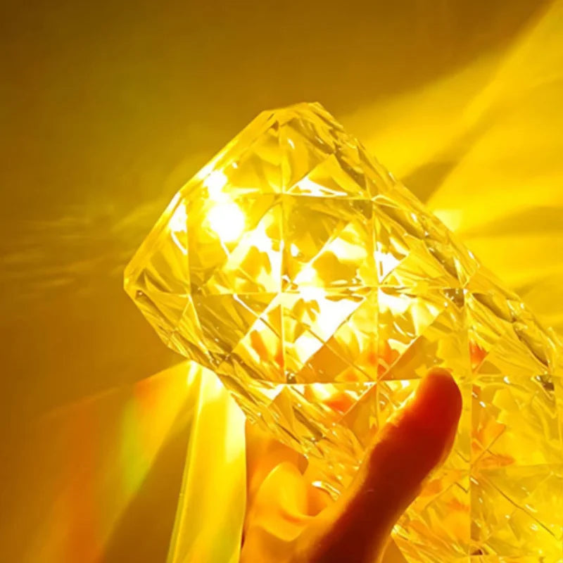 Hand holding the Crystal Mood Lamp glowing warm gold