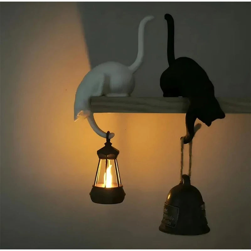 Gothic Cat Shelf Hook Figurines on a shelf with a glowing lantern at night