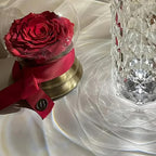 Crystal Mood Lamp beside a red rose on a table