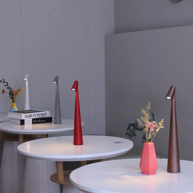 Glow Tube Cordless Lamps lighting cafe tables in a bright room