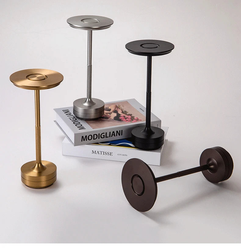 Sleek Cordless Table Lamps in several finishes on a table with books