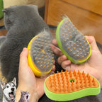 Hands holding the Pet Steam Grooming Brush full of loose cat hair