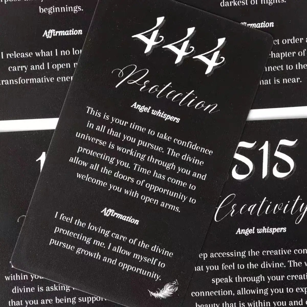 Close-up of Angel Number Affirmation Cards for 444 Protection and 515 Creativity