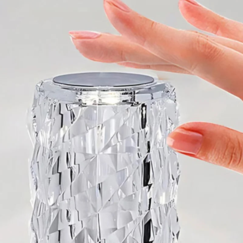 Hand touching the top of the Crystal Mood Lamp to switch it on