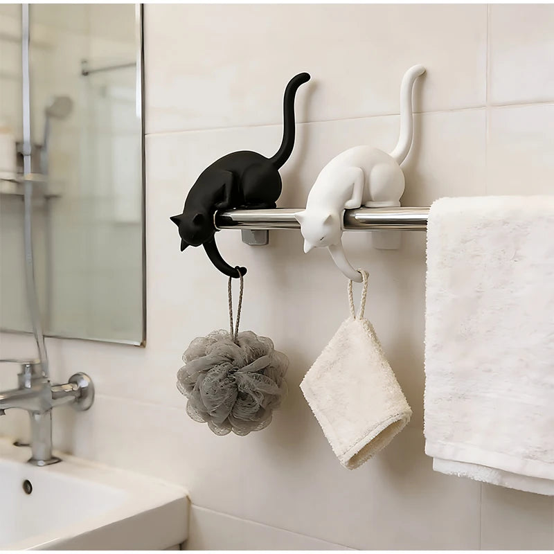 Gothic Cat Shelf Hook Figurines on a bathroom towel rail holding a loofah