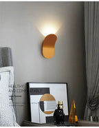 Gold Nordic Glow Wall Lamp glowing above a styled shelf