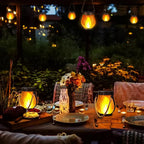 Solar Flickering Flame Lanterns hanging over a garden table at night